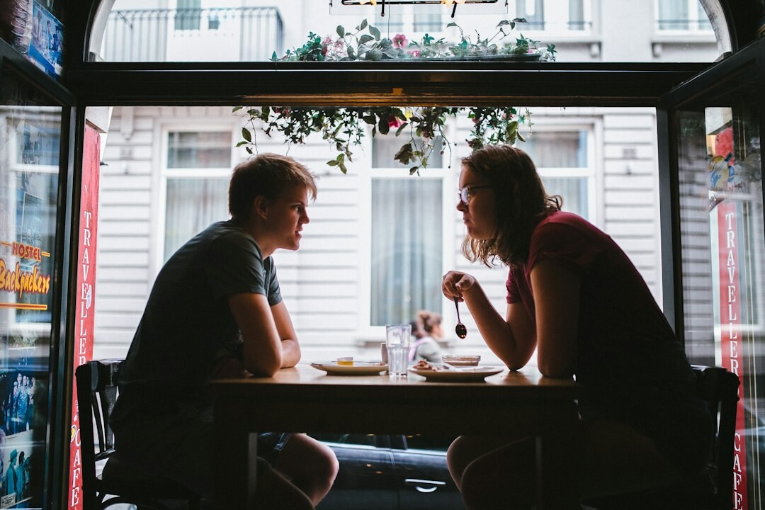 Two people having a survey interview conversation at a table